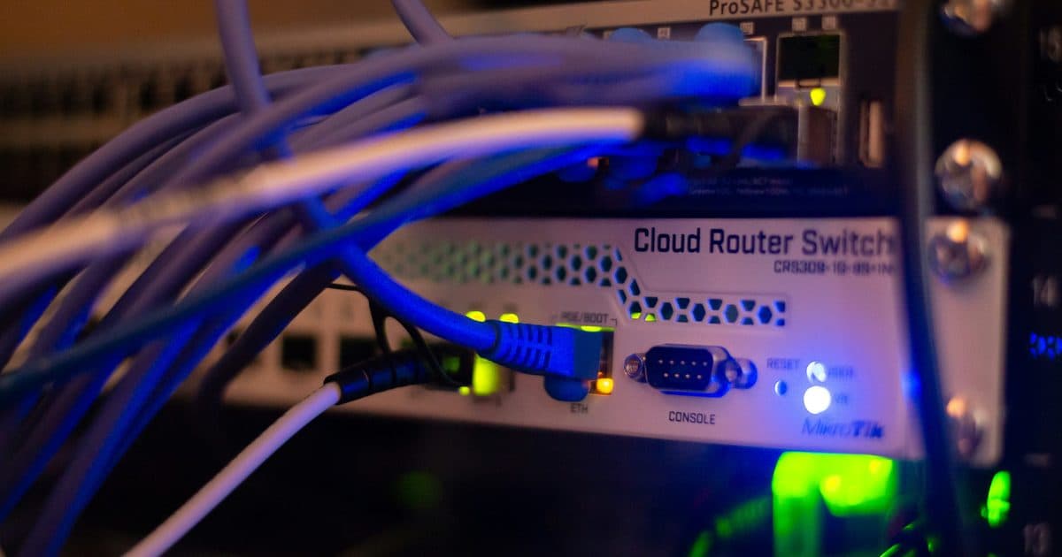 Close-up of a network switch with ethernet cables and LED status lights